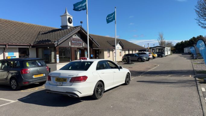 taxi collecting passenger at Parkdean Nairn Lochloy Caravan Park